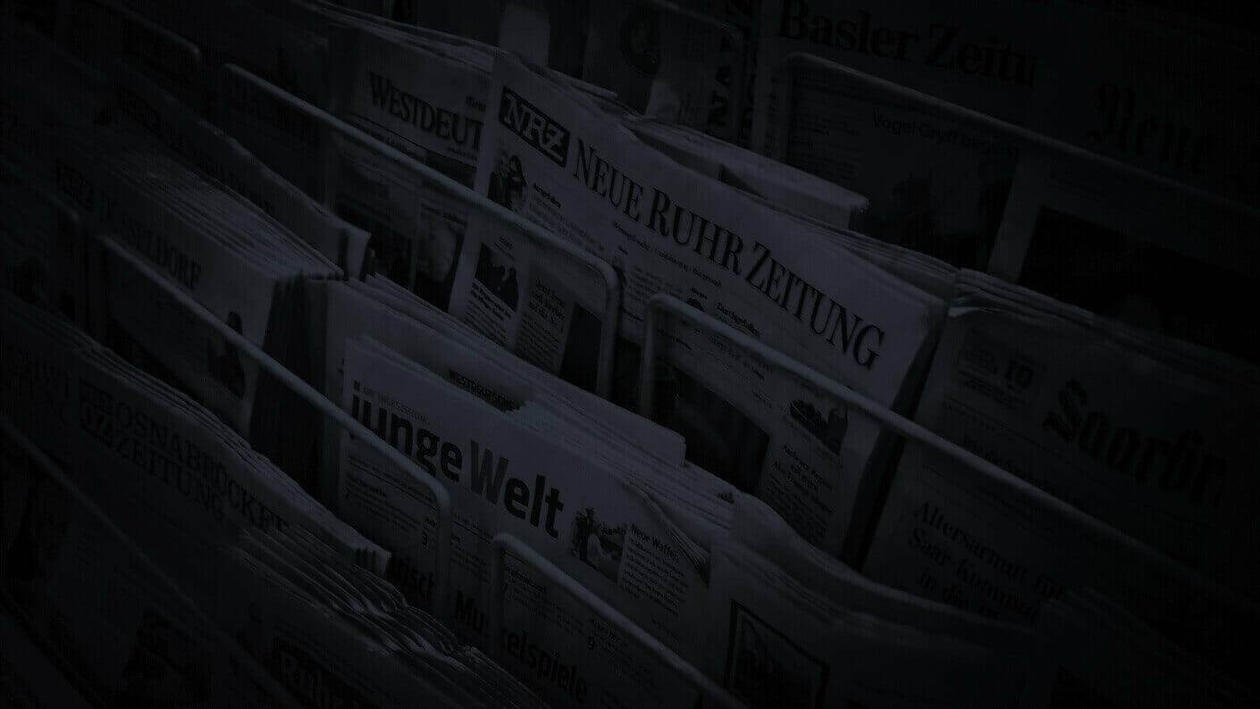 a rack of newspapers showcasing the most recent online marketing news.