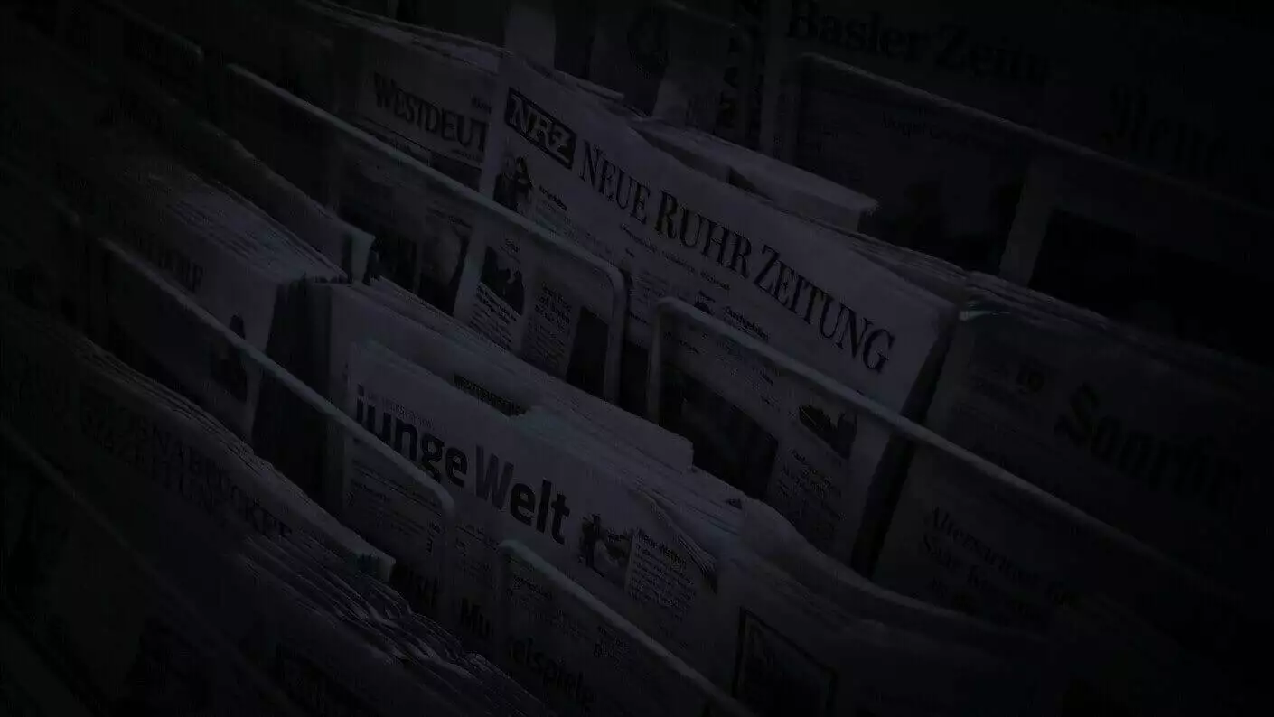 a rack of newspapers showcasing the most recent online marketing news.