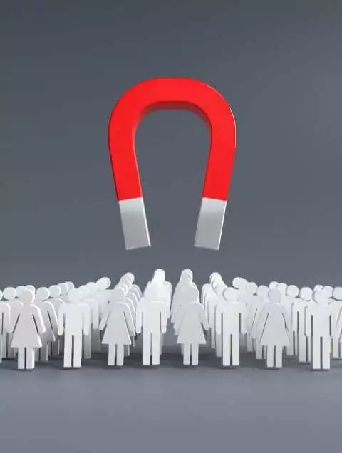 a large red horseshoe magnet hovering above a crowd of white silhouetted figures representing lead generation on a gray background.